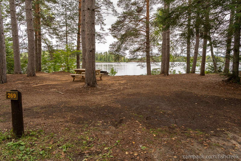 Campsite Photo of Site 297 at Fish Creek Pond Campground, New York - Looking at Site from Road Sign Visible