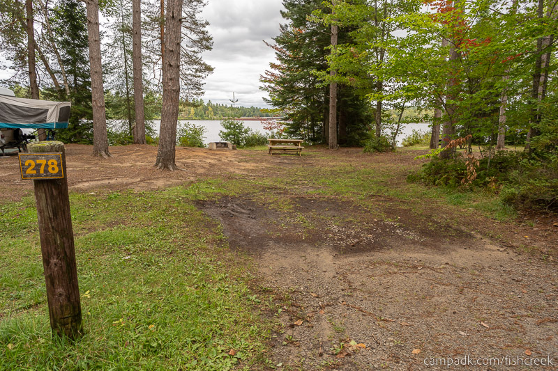 Campsite Photo of Site 306 at Fish Creek Pond Campground, New York - Looking at Site from Road Sign Visible