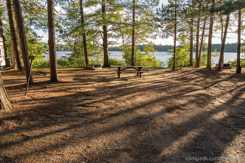 Campsite Photo of Site 117 at Fish Creek Pond Campground, New York - Looking at Site from Road Sign Visible