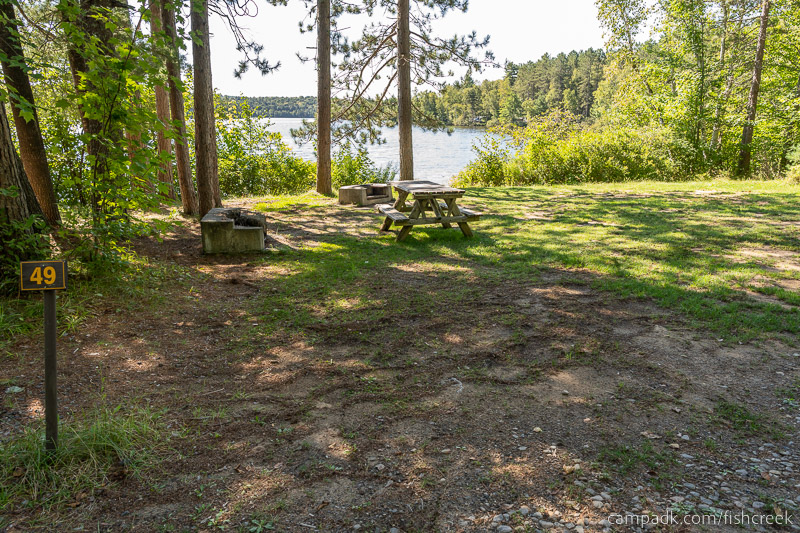 Campsite Photo of Site 59 at Fish Creek Pond Campground, New York - Looking at Site from Road Sign Visible