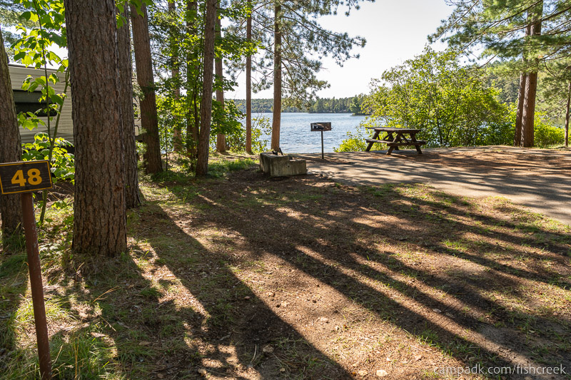 Campsite Photo of Site 58 at Fish Creek Pond Campground, New York - Looking at Site from Road Sign Visible