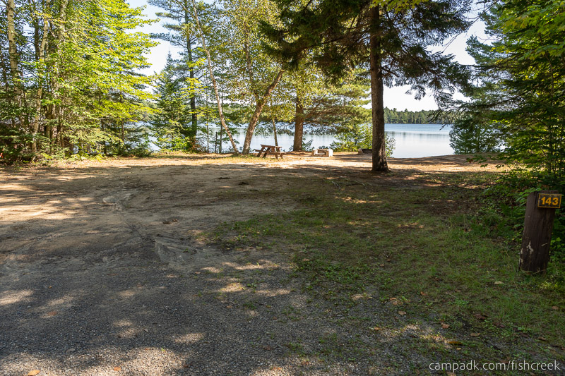 Campsite Photo of Site 173 at Fish Creek Pond Campground, New York - Looking at Site from Road Sign Visible