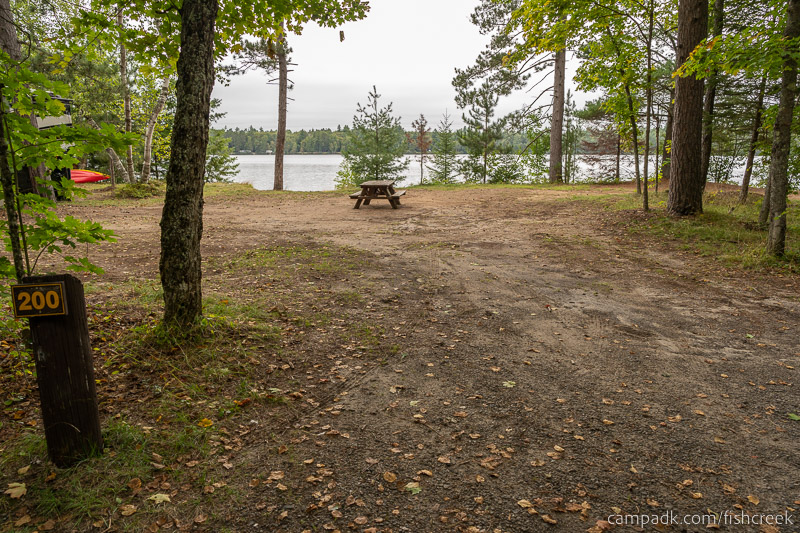 Campsite Photo of Site 228 at Fish Creek Pond Campground, New York - Looking at Site from Road Sign Visible