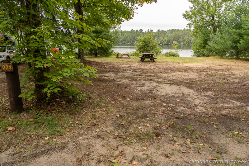 Campsite Photo of Site 252 at Fish Creek Pond Campground, New York - Looking at Site from Road Sign Visible