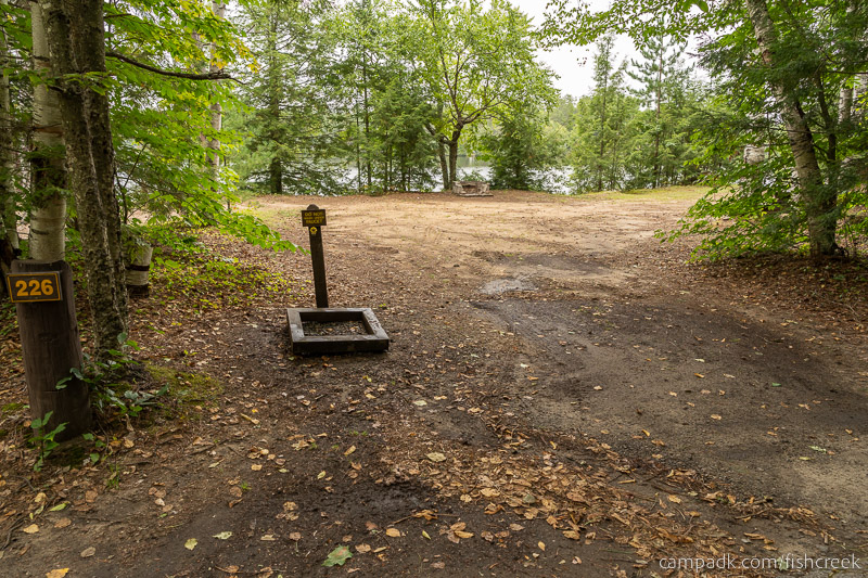 Campsite Photo of Site 254 at Fish Creek Pond Campground, New York - Looking at Site from Road Sign Visible