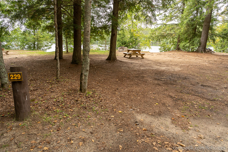 Campsite Photo of Site 257 at Fish Creek Pond Campground, New York - Looking at Site from Road Sign Visible