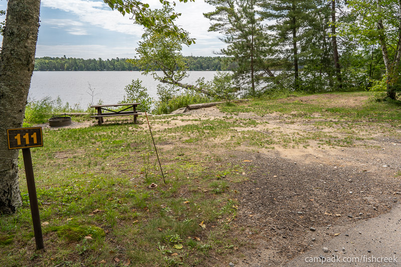 Campsite Photo of Site 143 at Fish Creek Pond Campground, New York - Looking at Site from Road Sign Visible