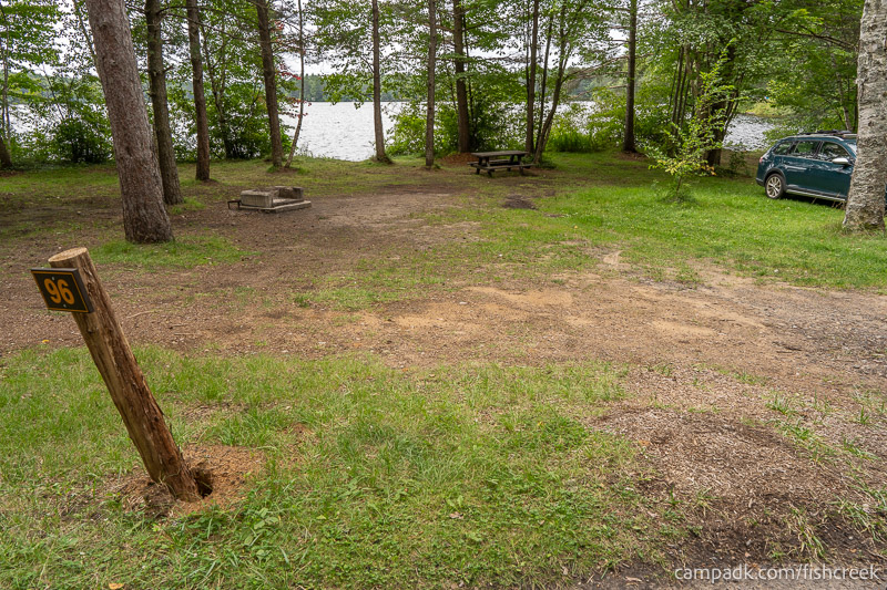 Campsite Photo of Site 128 at Fish Creek Pond Campground, New York - Looking at Site from Road Sign Visible