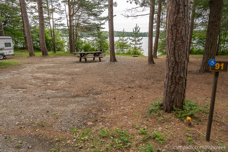 Campsite Photo of Site 123 at Fish Creek Pond Campground, New York - Looking at Site from Road Sign Visible