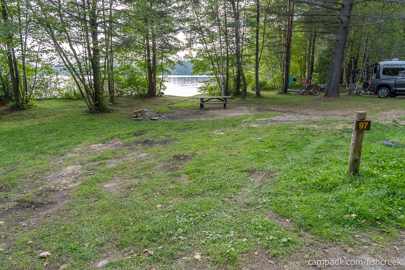 Campsite Photo of Site 129 at Fish Creek Pond Campground, New York - Looking at Site from Road Sign Visible
