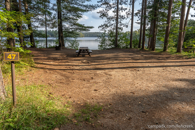 Campsite Photo of Site 57 at Fish Creek Pond Campground, New York - Looking at Site from Road Sign Visible