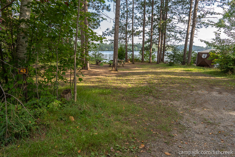 Campsite Photo of Site 53 at Fish Creek Pond Campground, New York - Looking at Site from Road Sign Visible