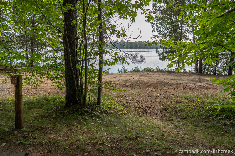 Campsite Photo of Site 141 at Fish Creek Pond Campground, New York - Looking at Site from Road Sign Visible