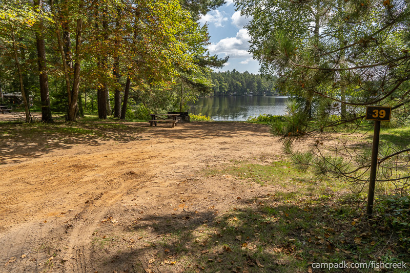 Campsite Photo of Site 49 at Fish Creek Pond Campground, New York - Looking at Site from Road Sign Visible