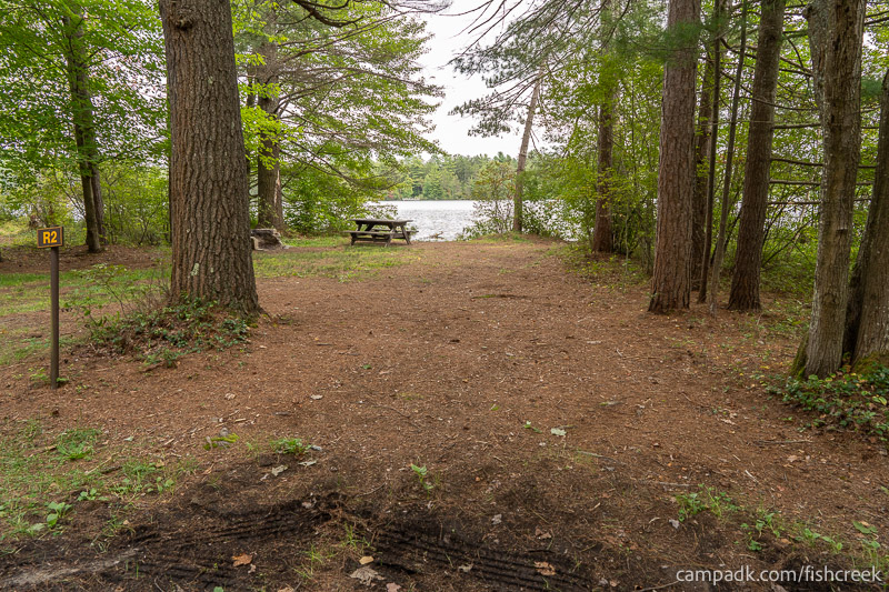 Campsite Photo of Site 85 at Fish Creek Pond Campground, New York - Looking at Site from Road Sign Visible
