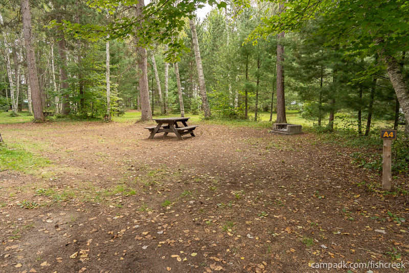 Campsite Photo of Site 70 at Fish Creek Pond Campground, New York - Looking at Site from Road Sign Visible