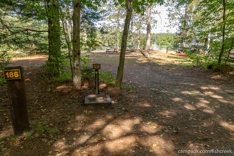 Campsite Photo of Site 214 at Fish Creek Pond Campground, New York - Looking at Site from Road Sign Visible