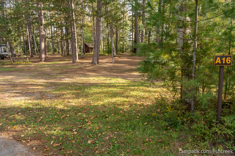Campsite Photo of Site 98 at Fish Creek Pond Campground, New York - Looking at Site from Road Sign Visible