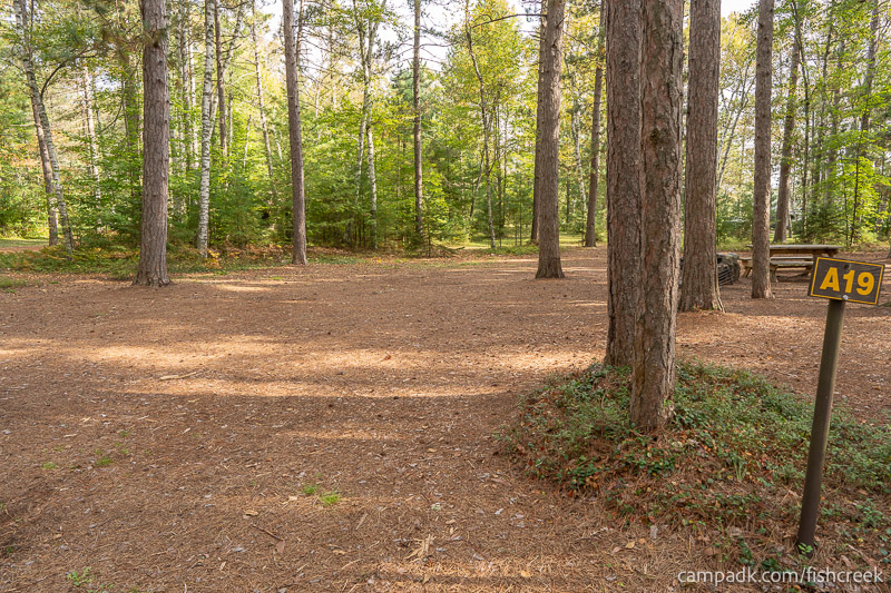 Campsite Photo of Site 103 at Fish Creek Pond Campground, New York - Looking at Site from Road Sign Visible