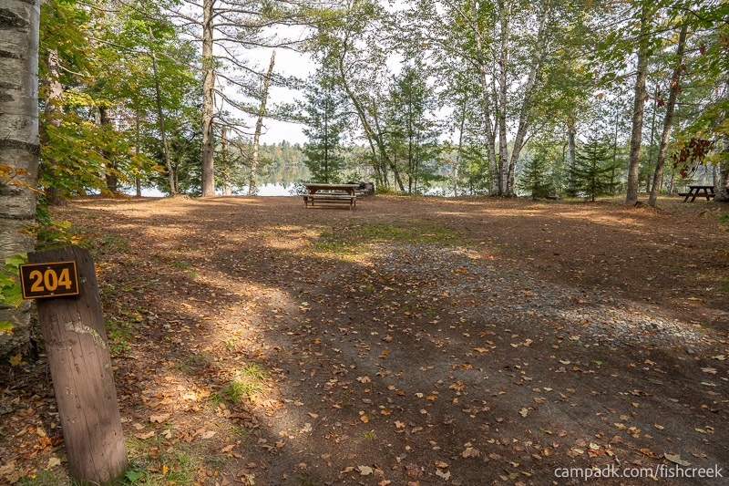 Campsite Photo of Site 232 at Fish Creek Pond Campground, New York - Looking at Site from Road Sign Visible
