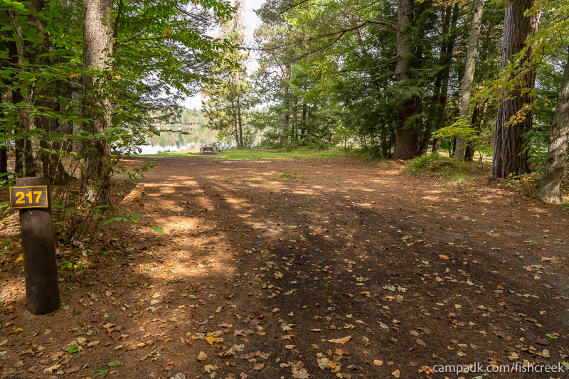 Campsite Photo of Site 245 at Fish Creek Pond Campground, New York - Looking at Site from Road Sign Visible