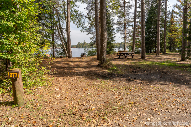 Campsite Photo of Site 305 at Fish Creek Pond Campground, New York - Looking at Site from Road Sign Visible