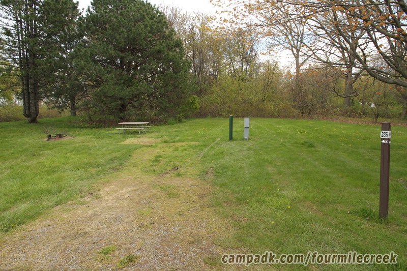 Campsite Photo of Site 285 at Four Mile Creek State Park, New York - Looking at Site from Road Sign Visible
