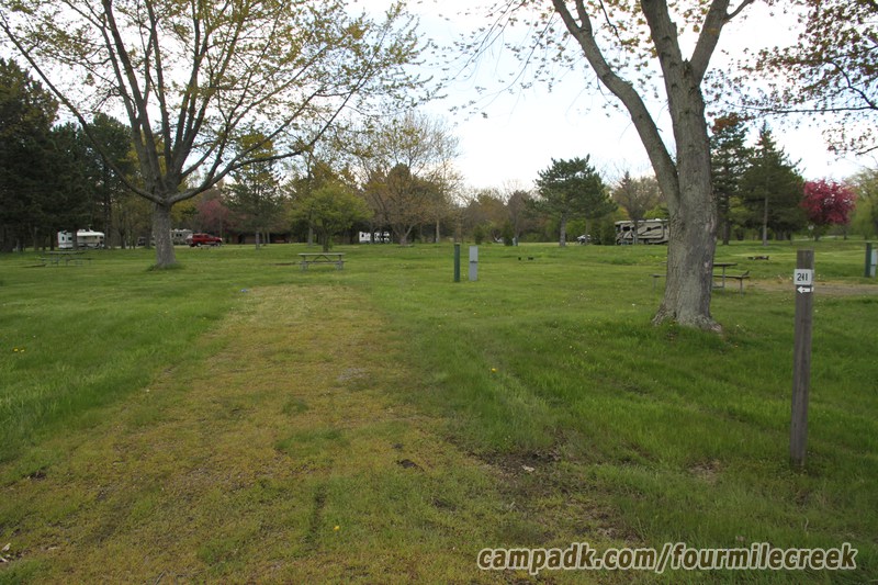 Campsite Photo of Site 211 at Four Mile Creek State Park, New York - Looking at Site from Road Sign Visible