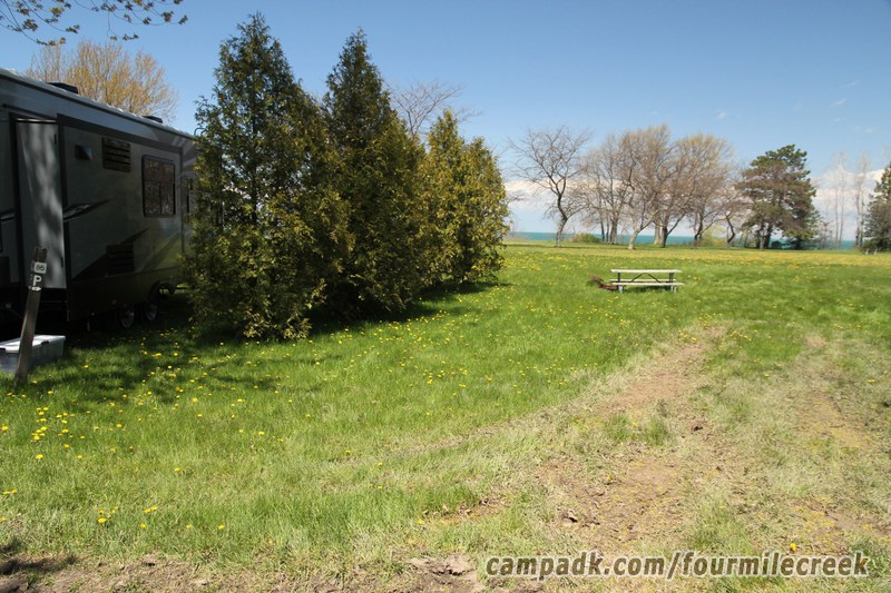 Campsite Photo of Site 85 at Four Mile Creek State Park, New York - Looking at Site from Road Sign Visible