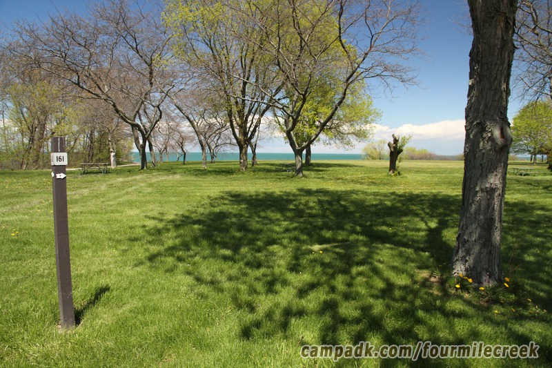 Campsite Photo of Site 161 at Four Mile Creek State Park, New York - Looking at Site from Road Sign Visible