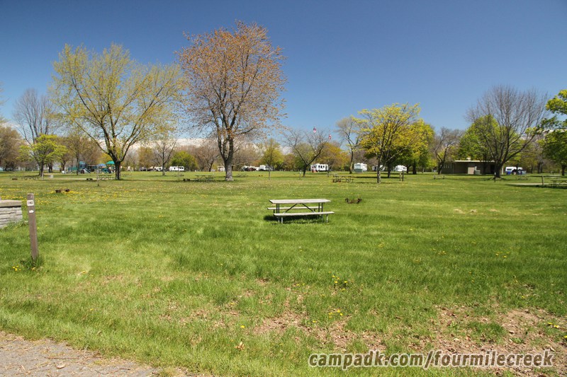 Campsite Photo of Site 140 at Four Mile Creek State Park, New York - Looking at Site from Road Sign Visible