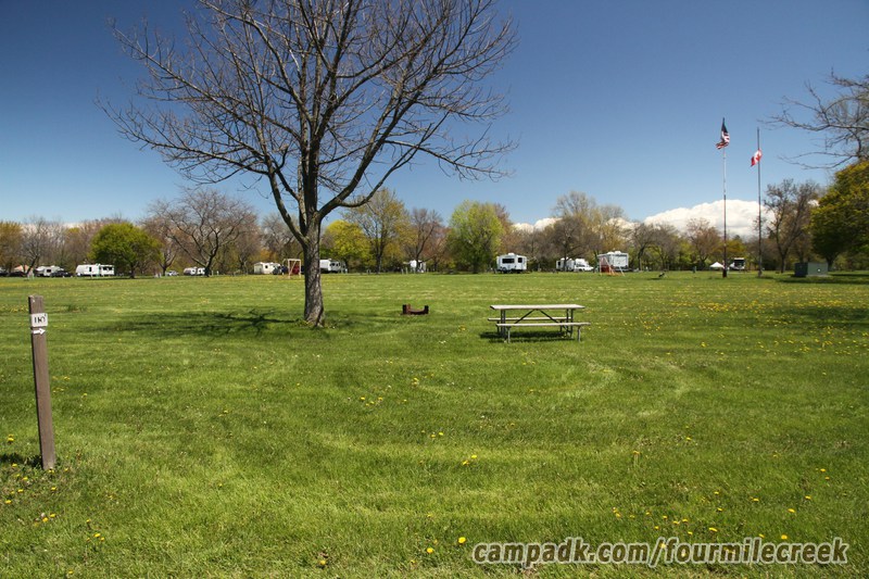 Campsite Photo of Site 110 at Four Mile Creek State Park, New York - Looking at Site from Road Sign Visible