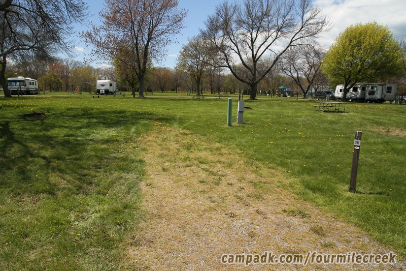 Campsite Photo of Site 26 at Four Mile Creek State Park, New York - Looking at Site from Road Sign Visible