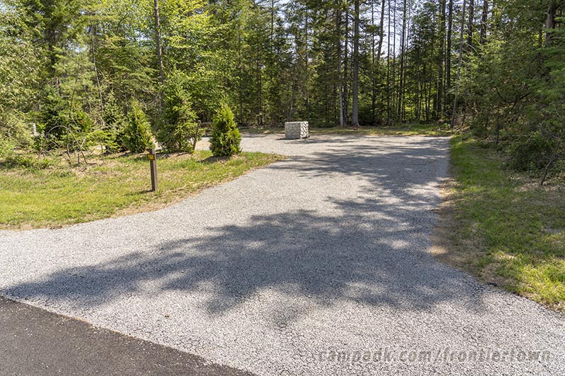 Campsite Photo of Site T68 at Frontier Town Campground, New York - Looking at Site from Road Sign Visible