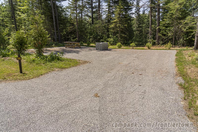 Campsite Photo of Site T83 at Frontier Town Campground, New York - Looking at Site from Road Sign Visible