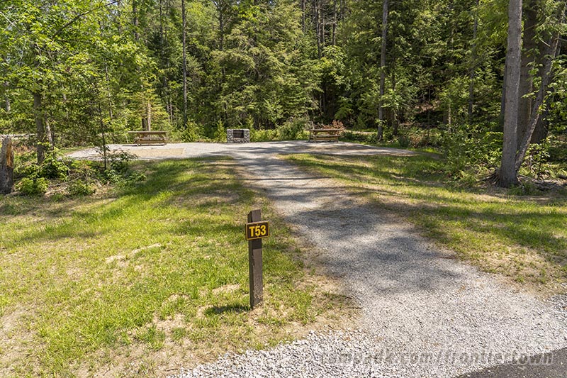 Campsite Photo of Site T53 at Frontier Town Campground, New York - Looking at Site from Road Sign Visible