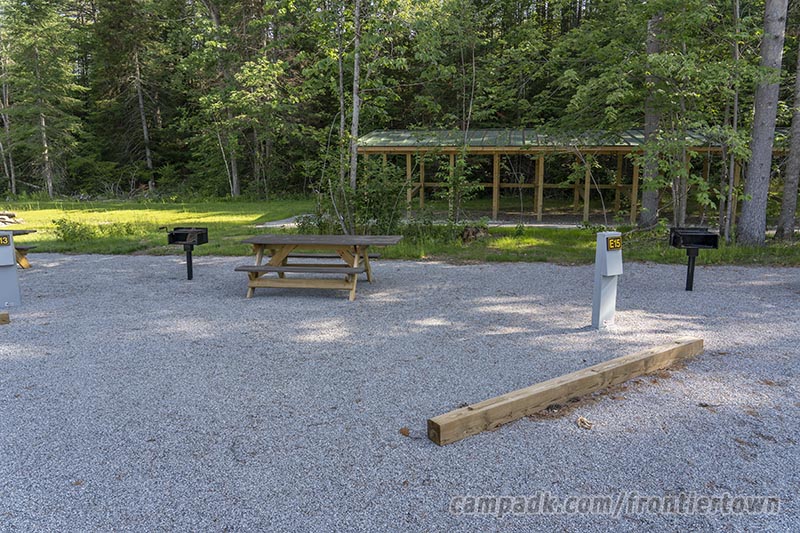 Campsite Photo of Site E15 at Frontier Town Campground, New York - Looking at Site from Road Sign Visible