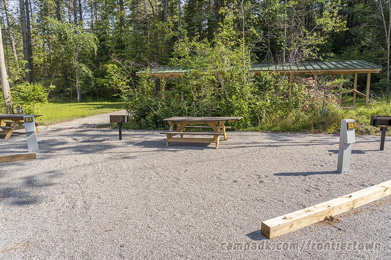 Campsite Photo of Site E5 at Frontier Town Campground, New York - Looking at Site from Road Sign Visible
