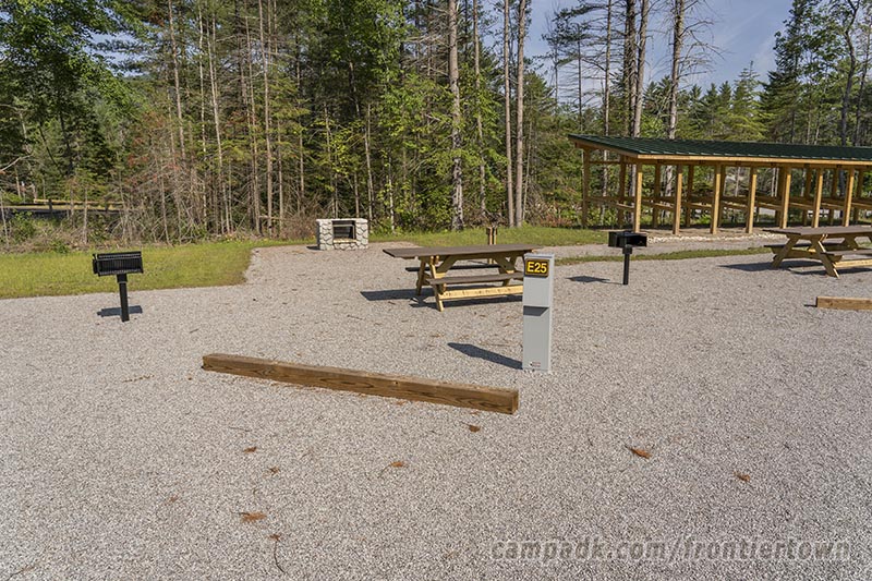 Campsite Photo of Site E25 at Frontier Town Campground, New York - Looking at Site from Road Sign Visible