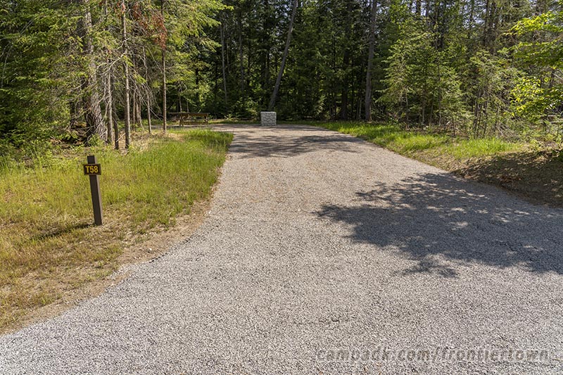 Campsite Photo of Site T58 at Frontier Town Campground, New York - Looking at Site from Road Sign Visible