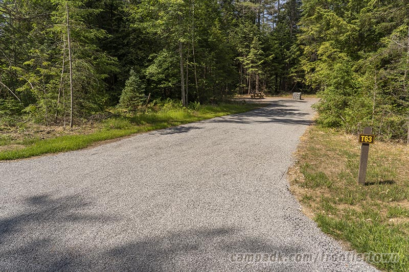 Campsite Photo of Site T63 at Frontier Town Campground, New York - Looking at Site from Road Sign Visible