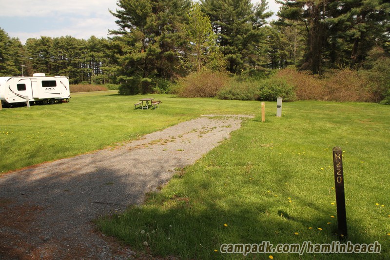 Campsite Photo of Site 220 at Hamlin Beach State Park, New York - Looking at Site from Road Sign Visible