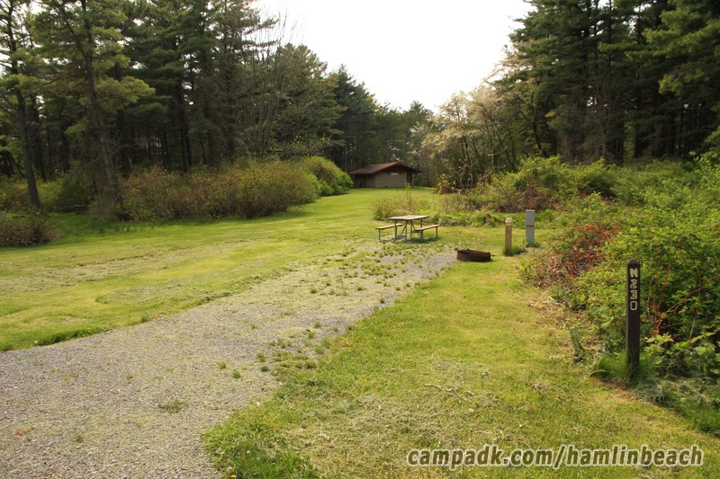 Campsite Photo of Site 230 at Hamlin Beach State Park, New York - Looking at Site from Road Sign Visible