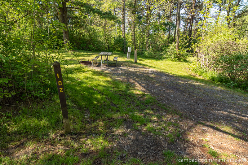 Campsite Photo of Site 102 at Hamlin Beach State Park, New York - Looking at Site from Road Sign Visible