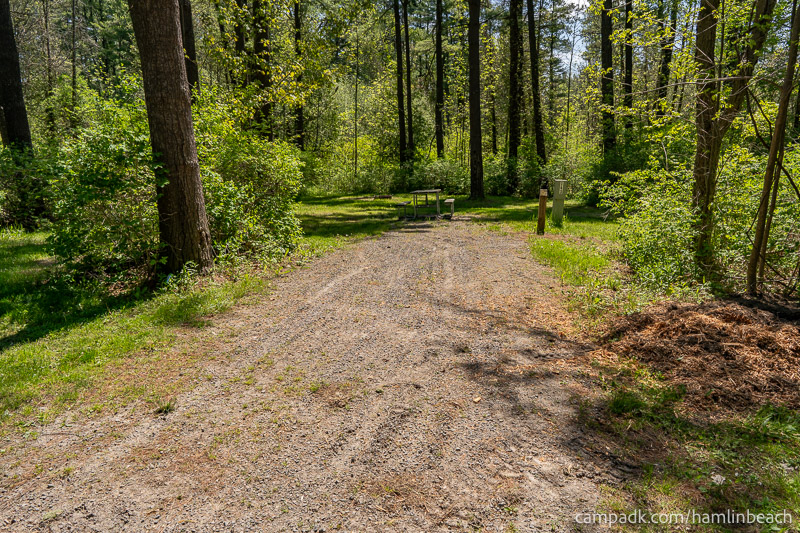 Campsite Photo of Site 143 at Hamlin Beach State Park, New York - Looking at Site from Road Sign Visible