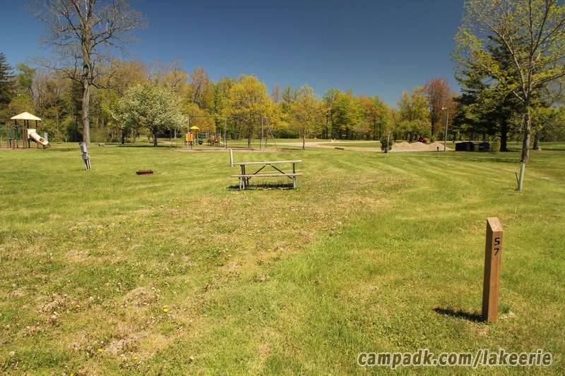 Campsite Photo of Site 57 at Lake Erie State Park, New York - Looking at Site from Road Sign Visible