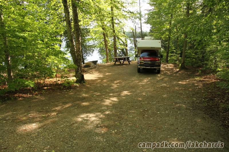 Campsite Photo of Site 86 at Lake Harris Campground, New York - Looking at Site from Road Sign Visible