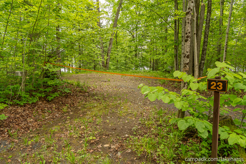 Campsite Photo of Site 23 at Lake Harris Campground, New York - Looking at Site from Road Sign Visible