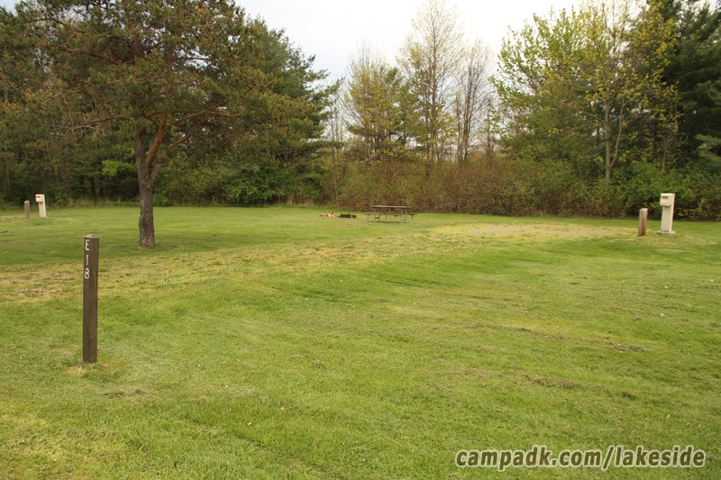 Campsite Photo of Site E18 at Lakeside State Park, New York - Looking at Site from Road Sign Visible