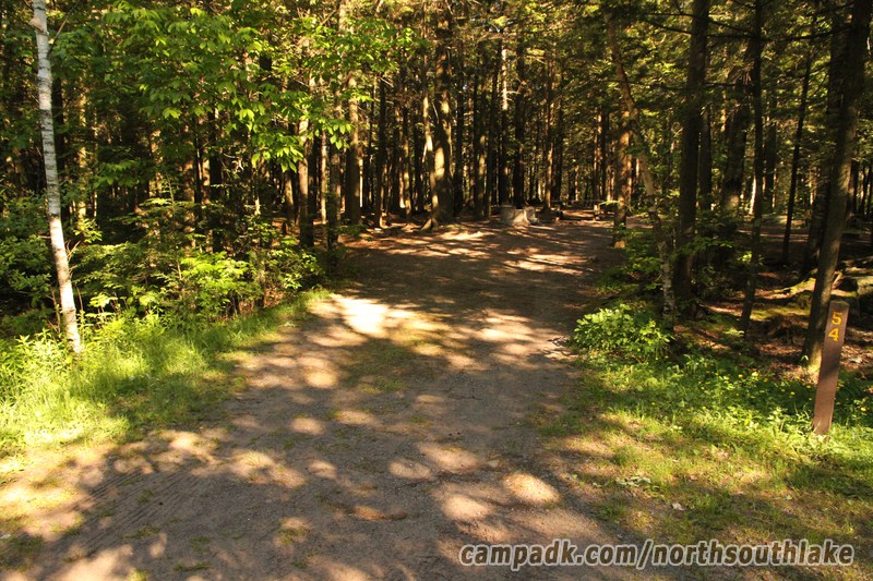 Campsite Photo of Site 54 at North South Lake Campground, New York - Looking at Site from Road Sign Visible